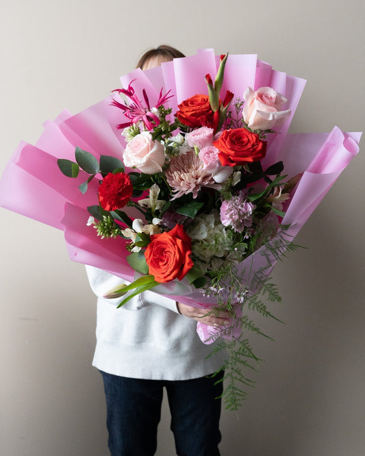 A large and beautiful Valentine's Day bouquet with red roses and pink flowers