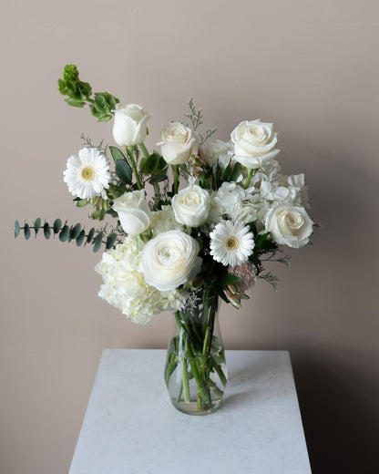 All white sympathy flower arrangement to send to funeral homes in Toronto