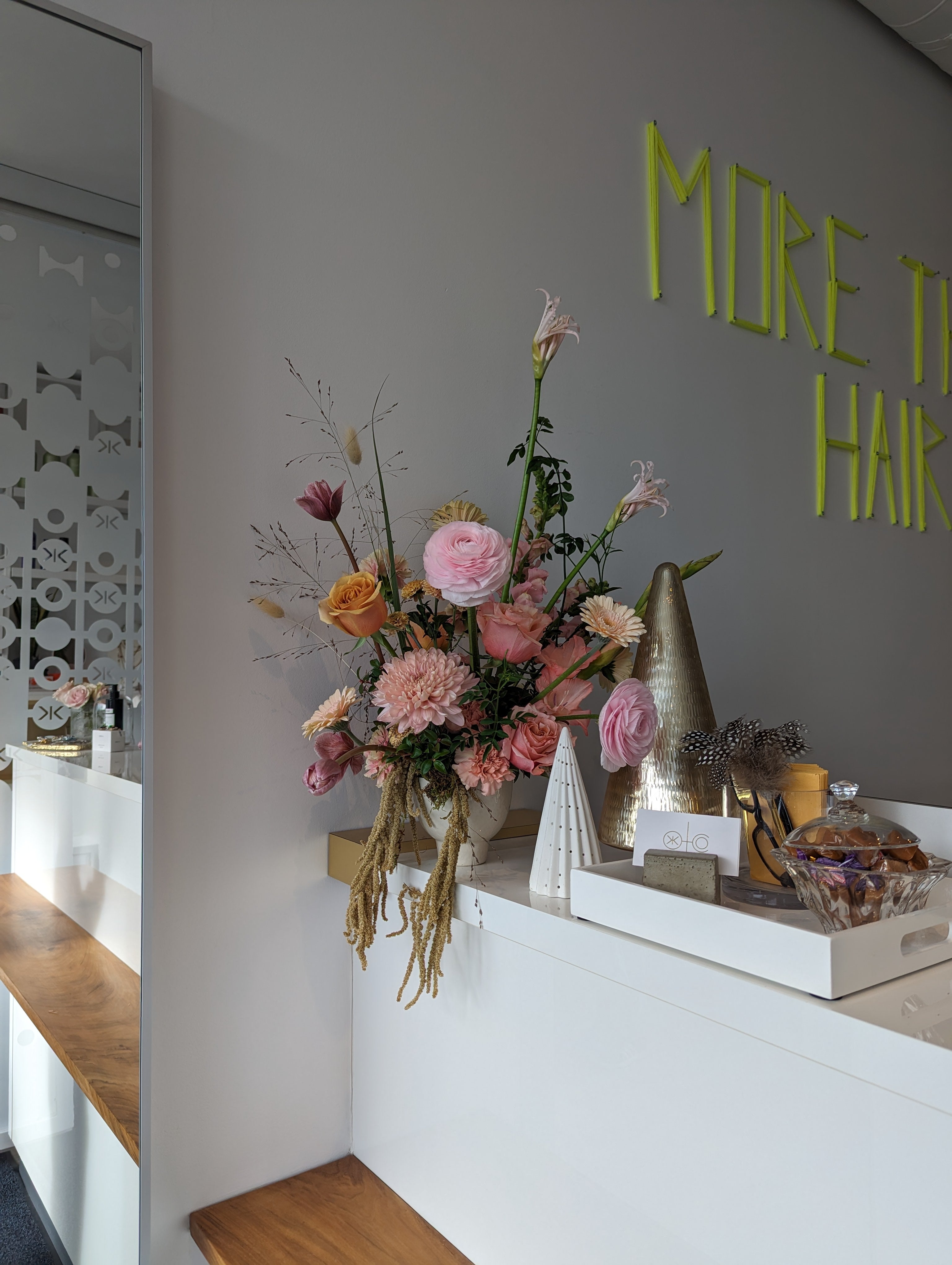 Flowers at a salon reception desk by May Flowers